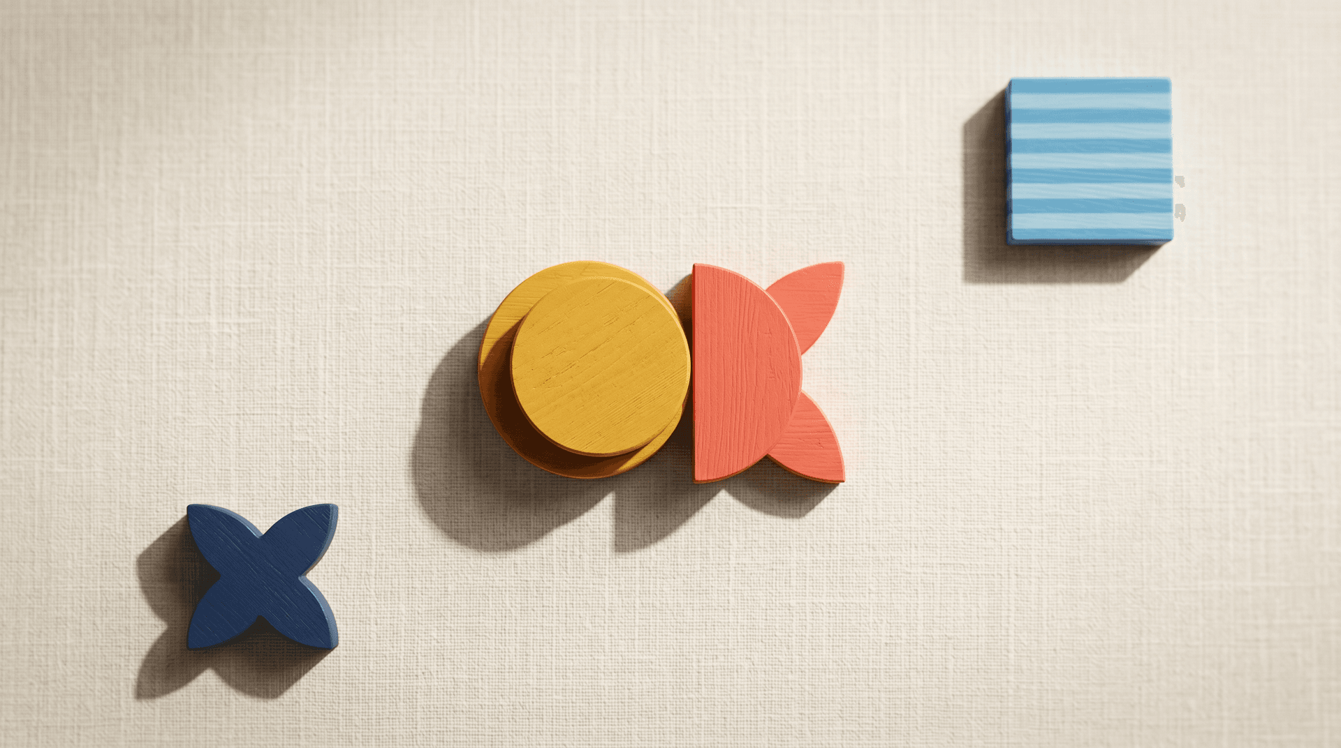 Golden circle overlapping a coral half-moon in the center surrounded by single spaced Bauhaus blocks on cream linen